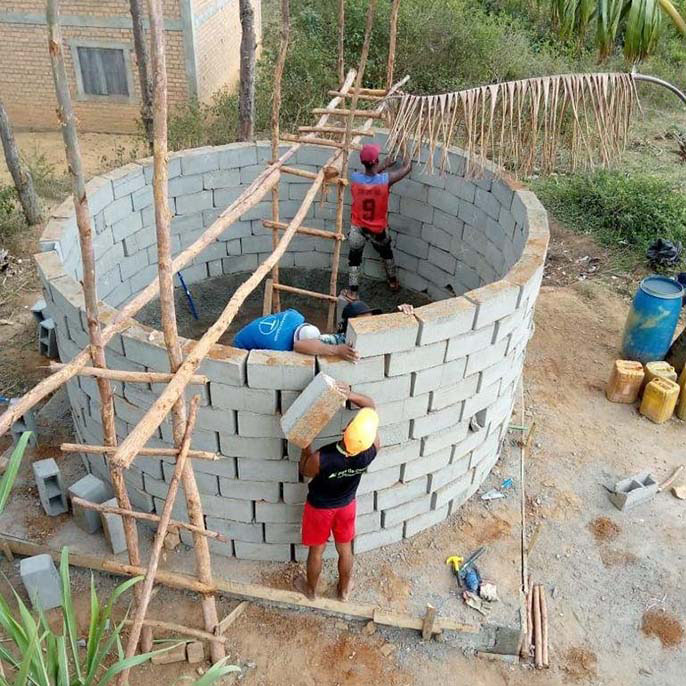 community members build a well in a Madagascan town